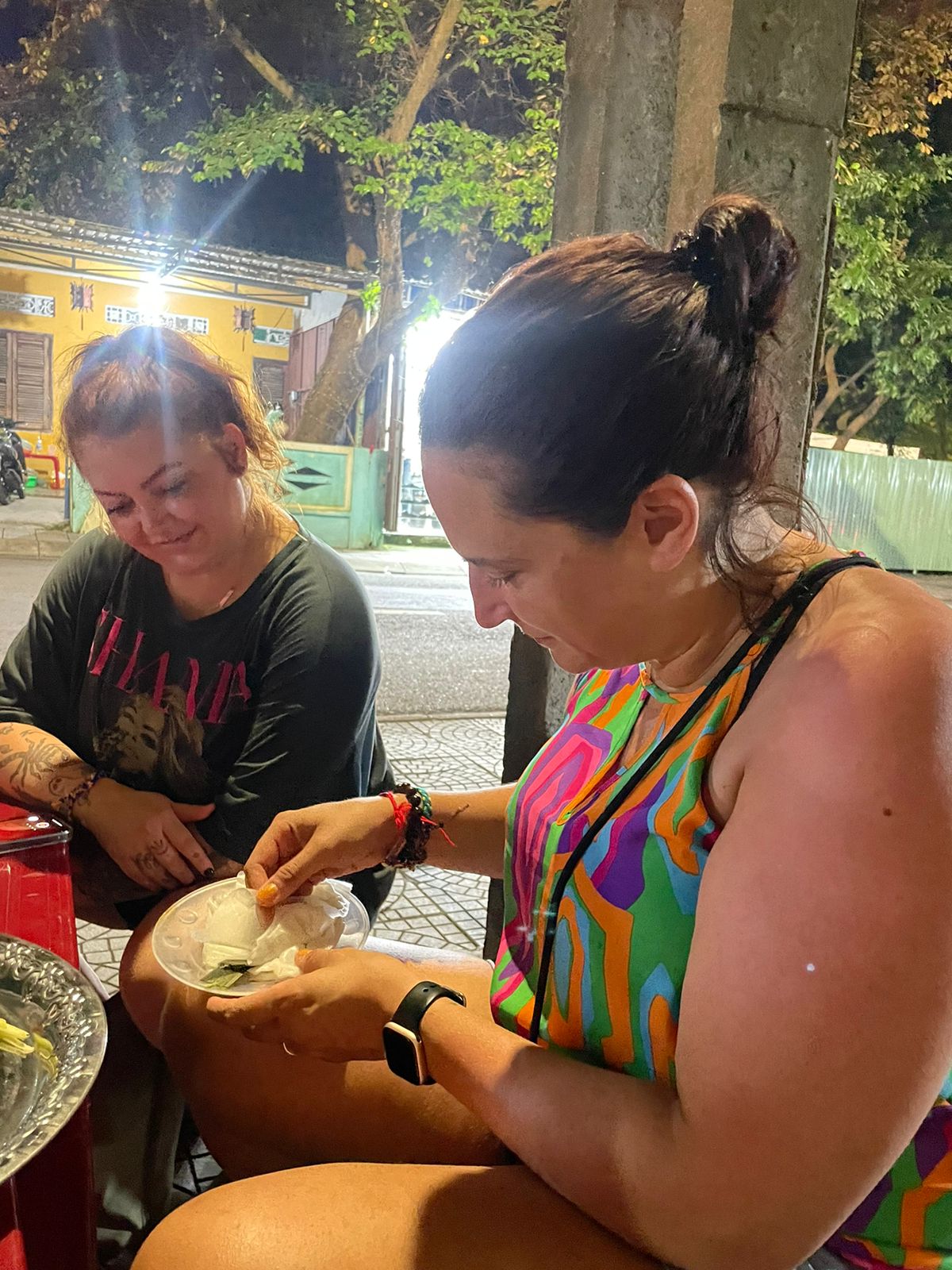 Guests tasting White Rose dumplings at a street stall